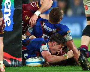 Cam Roigard scores the last-gasp try that secured defeat for the Highlanders in Wellington. Photo...