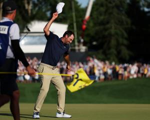Scottie Scheffler celebrates his third major title on the 18th green at Quail Hollow. Photo:...