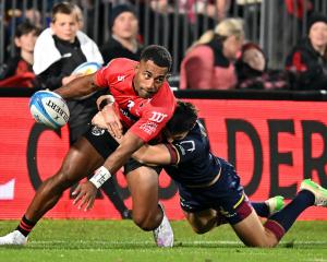 Crusaders winger Sevu Reece looks to get an offload away against the Highlanders. Photo: Getty...