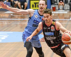 Canterbury Rams guard Taylor Britt slips around Otago Nuggets captain Darcy Knox during a...
