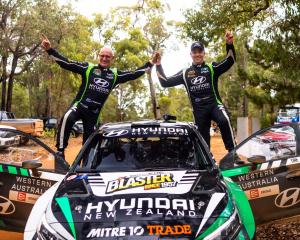 Hayden Paddon (right) and co-driver John Kennard celebrate after their win in the Forest Rally in...