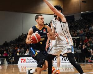 Otago Nuggets forward Jono Janssen drives at Hawke's Bay Hawks big Luca Yates at the Edgar Centre...