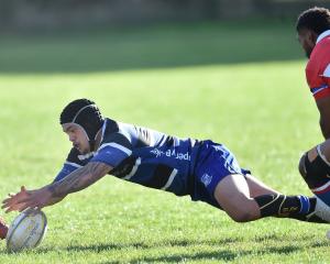 Kaikorai midfielder Dante Hihi dives on the loose ball while watched by Harbour winger Waisake...