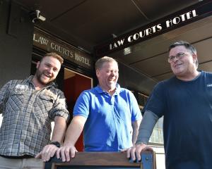 Outside the Law Courts Hotel are (from left) PKB builders contractor Paul Kirby and new owners...
