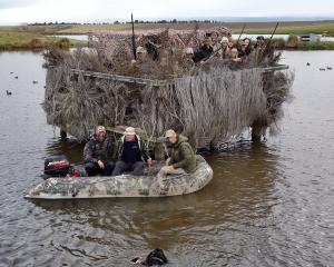 In a boat while duck-shooting near Ranfurly on Saturday are (from left): Warren, Bryan and Gus...