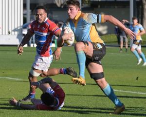 University’s Lanson Randell steps past the tackle of Harbour halfback Tetauru Cuthers, with Toni...