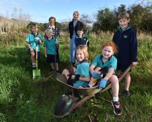 East Taieri School pupils Aubrey Gregory (left), 7, and Sophie Lind, 7, sit in a wheel barrow...