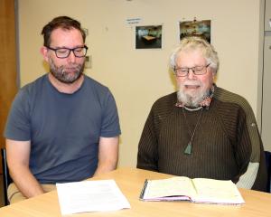 Dr Nicholas Bowden (left) and Emeritus Prof Warren Tate examine research on the needs of people...