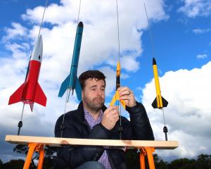 Otago Rocketry Club founder Mike Turner checks a model before the workshops next week. Photos:...