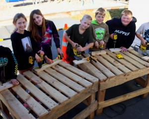 Learning how to safely operate carpentry equipment are Outram School pupils (from left) Liam...