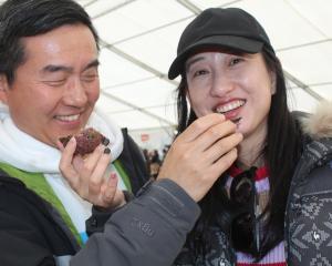 Tasting Bluff oysters are Ley Chen (left) and Yuwhan Xu at the Bluff Oyster and Food Festival on...