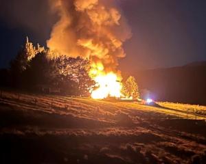 The house on fire in Waikaia in February. Photos: NZ Police