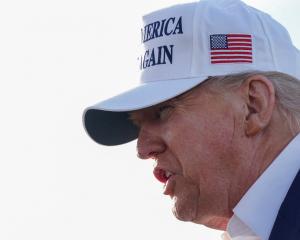 US President Donald Trump speaks to the media before boarding Air Force One in Morristown, New...
