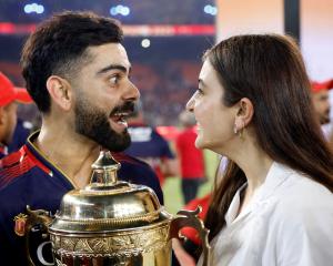 Royal Challengers Bengaluru batter Virat Kohli and wife Anushka Sharma celebrate with the winner...
