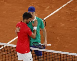 Jannik Sinner embraces Novak Djokovic after winning his semi final match. Photo: Reuters 
