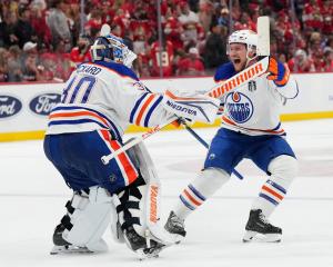 Edmonton Oilers goaltender Calvin Pickard (30) celebrates with centre Jeff Skinner (53) after...