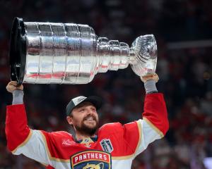 Florida Panthers forward Sam Reinhart hoists the Stanley Cup after his side beat the Edmonton...