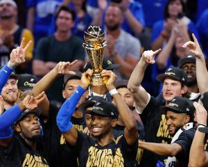 Oklahoma City Thunder players celebrate as Shai Gilgeous-Alexander lifts the Larry O'Brien...