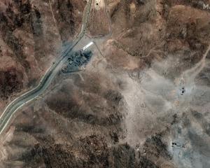 A satellite image shows airstrike craters on the perimeter of the Fordow Fuel Enrichment Facility...