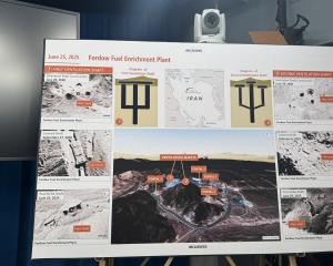 A poster of Iran's Fordow Fuel Enrichment Plant is displayed during a press briefing with US...