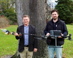 Prof Richard Green, left, and Dr Sam Schofield with the new chainsaw drone they’ve developed as...