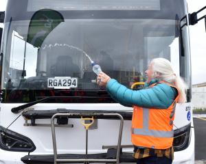 Queenstown-based Otago regional councillor Alexa Forbes christens a new electric bus with a...