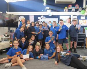 Clyde Primary School teacher Sydney Robertson and the year 6 and 7 Korimako class show off with...