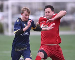 Otago University’s Blake Allison (left) battles for the ball with Northern Hearts’ Bradley...