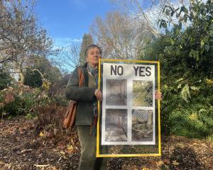 Nikki Broad holds a placard she has made protesting the lack of greenery in Gore aviary. PHOTOS:...