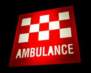 Australian Ambulance sign illuminated at night. Photo: Getty Images
