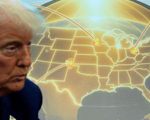 US President Donald Trump speaks in front of a map of Trump's proposed Golden Dome missile...