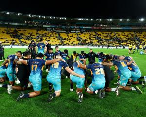 Moana Pasifika form a huddle after the round 16 Super Rugby Pacific match between Hurricanes and...