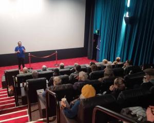 Chris Rottenberry and Grace Rottenberry hold daughter Mia, 2, at the first screening in the newly...