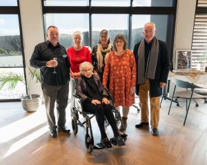 Olive, Lady Hutchins, pictured on her 100th birthday on Saturday in Queenstown, surrounded by her...
