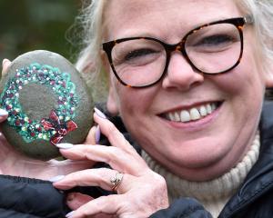 Clair Carson holds the Talyllyn Rock, which has been hidden at the Dunedin Botanic Garden after...