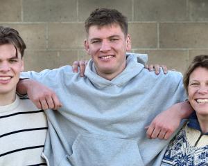 New All Black Fabian Holland (centre) with brother Quinten and mum Margot at the Dunedin Rugby...