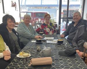 Members of a local community aphasia support group gather for coffee and conversation at a...