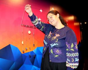 Events manager Rachel MacJeff holds a baby constellation mobile, one of many items people can...