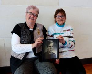 Not forgotten. . . Cousins Judy Kitto (left) and Shirley Campbell show a photo of their uncle...