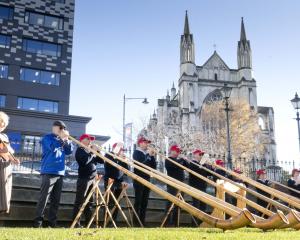 The Taranaki Swiss Club Alphorn Group performs in the Octagon, conducted by Alan Beck (below),...