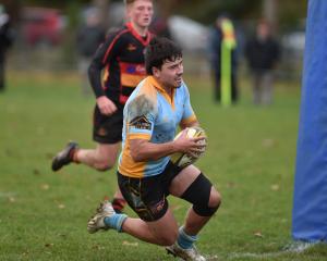 University second five Mac Harris dives over for a try against Zingari-Richmond during a Dunedin...