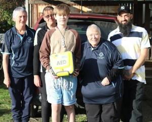Presenting a defibrillator to Aiden Cottrell (centre) and his father Luka (right) are Wyndham...