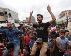 Palestinians celebrate the ceasefire in Khan Younis in the southern Gaza Strip. Photo: Reuters