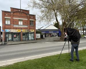 Laurence Aberhart takes a photo of the old fire station building in Gore with his large format...