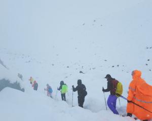 Hikers are guided to safety after a snow storm left them stranded near the face of Everest. Photo...