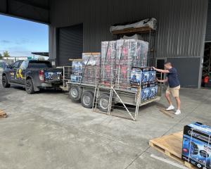 Stihl Shop Winton owner Fraser Guise loads generators onto the trailer in Nelson before making...