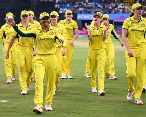 Australia legspinner Alana King walks off with the match ball after taking a record-breaking...