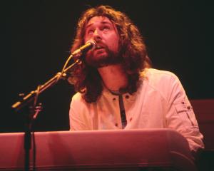 English musician and keyboard player Rick Davies performs live on stage with Supertramp on tour...