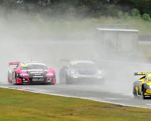 The Lamborghini Huracan driven by Brendon Leitch and Matt Day beside a Porsche 992 driven by...