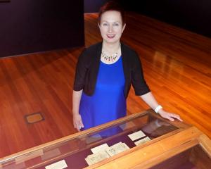Prof Simone Celine Marshall inspects a collection of medieval books of hours at the Dunedin...